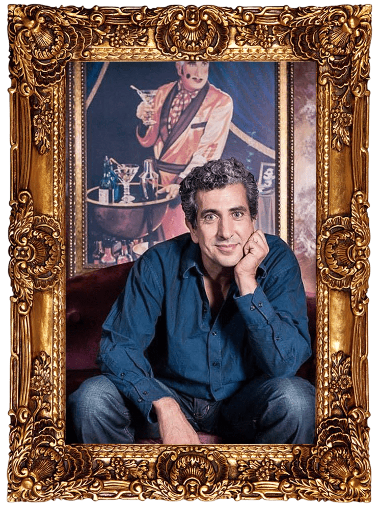 Frank Ferrante smiling in a blue shirt, portrait photo